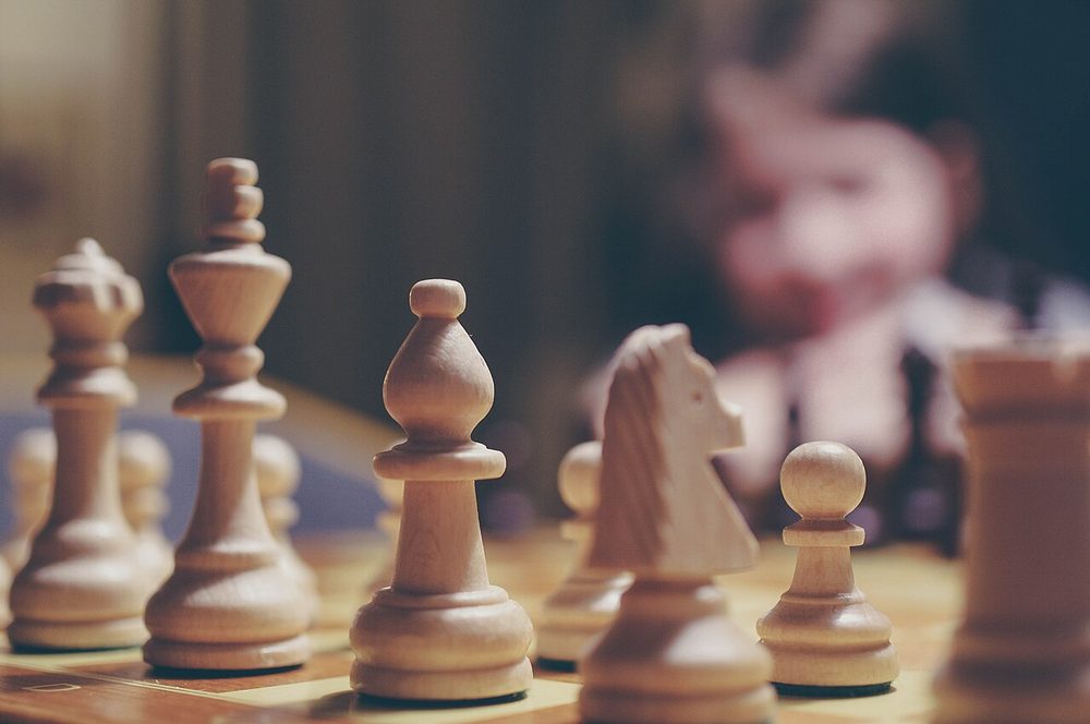 Chess pieces on a board mid-game