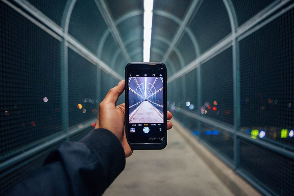 Smartphone held in a hand on a walkway